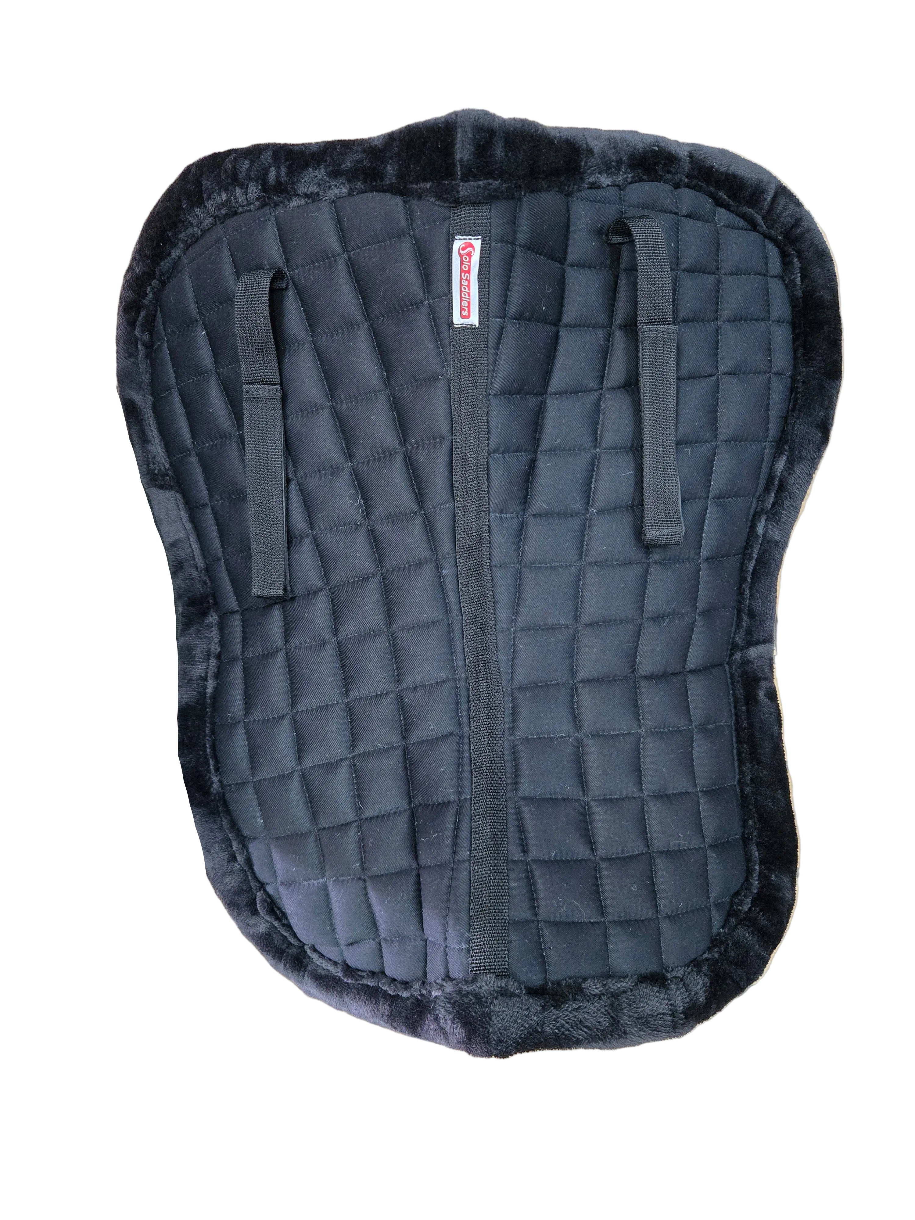 Black quilted saddle pad with a visible brand logo on a tiled floor background